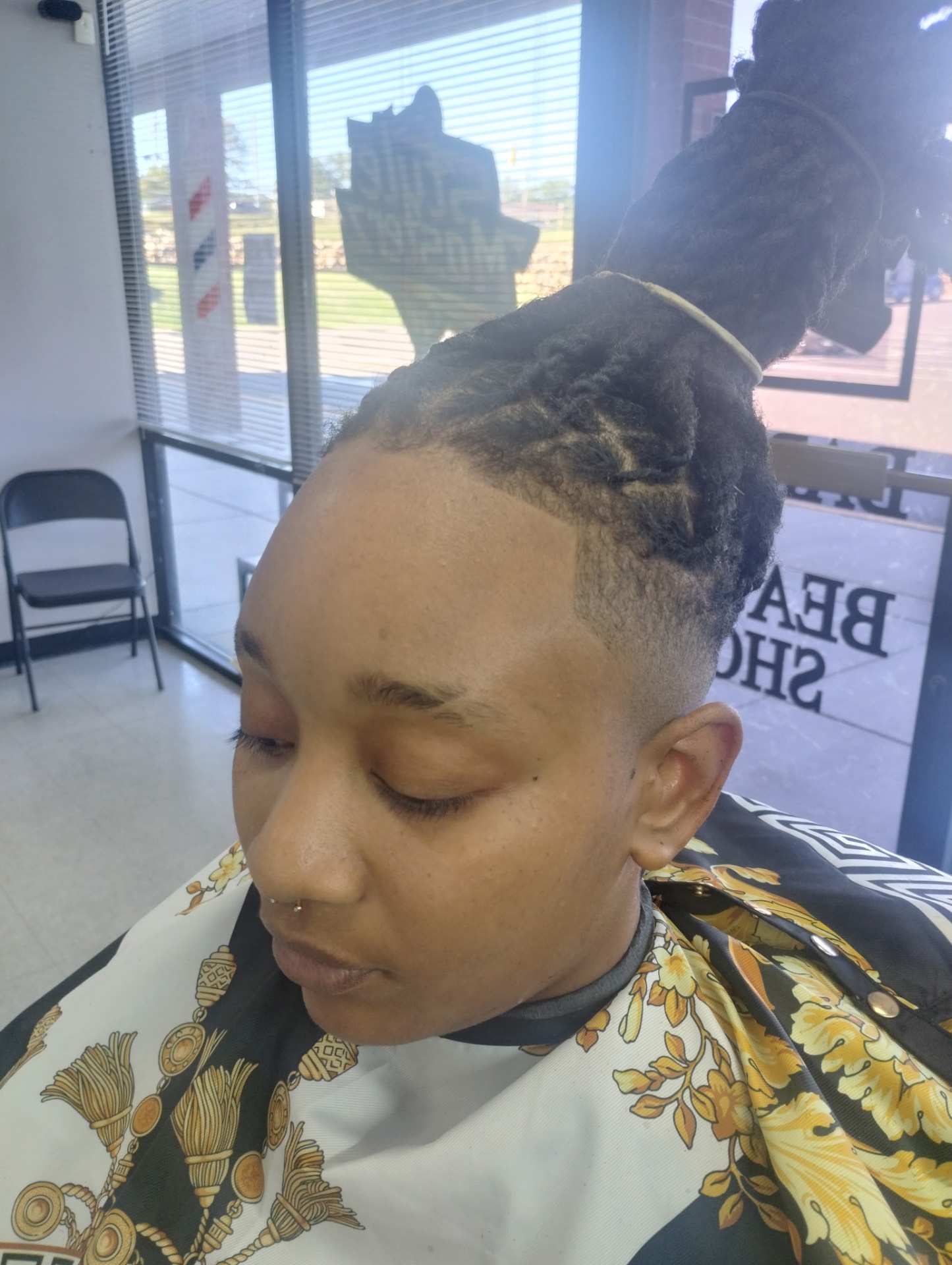 Women's loc updo with bald fade and clean lineup
