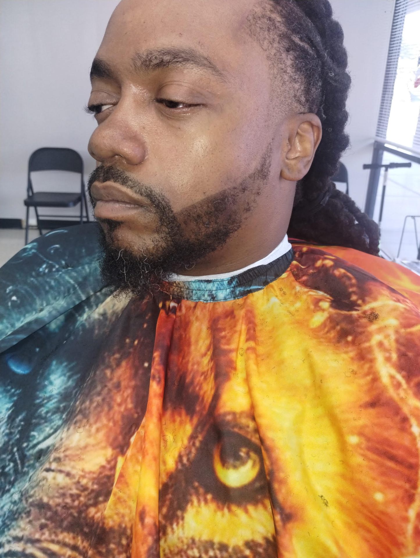Locs styled with full beard detail